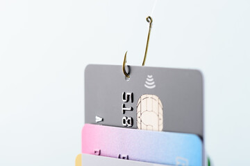 Credit card phishing scam concept. Credit card data theft, card hooked by hacker cyber criminal on fishing hook.