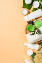 Spa wellness background. Natural spa products with bath towels, massage brush and green leaves....