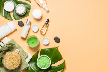 Spa wellness background. Natural spa products with bath towels, massage brush and green leaves. Flat lay image.