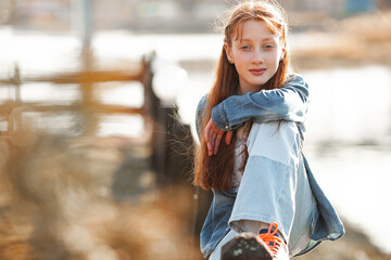 Cute red haired girl portrait. Pretty teen outdoors. Redhaired teenager.