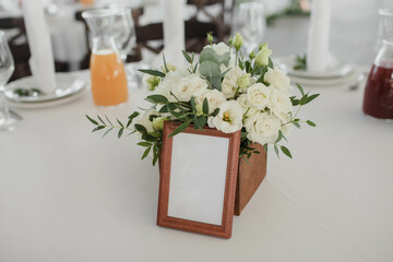 Wedding table for guests with seating number and flowers