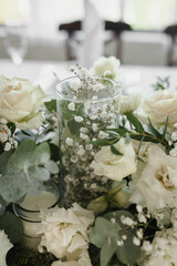 Decoration of the wedding table of the newlyweds, candles, gypsophila, eustoma, rose, eucalyptus