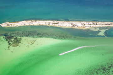 Florida beach. Paradise Summer vacation. Panorama of Dunedin Causeway, Honeymoon Island State Park. Blue-turquoise color of salt water. Ocean or Gulf of Mexico. Tropical Nature. America. Aerial view