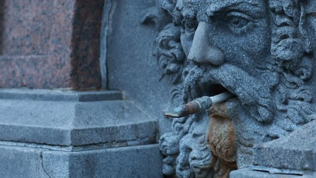 stone head of a man ancient parched fountain panorama