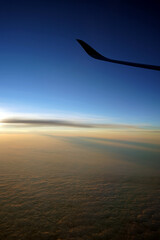 View from airplane window on the wing on sunset time.