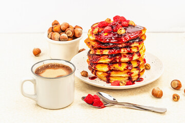 Traditional homemade breakfast with pancakes and coffee. Raspberry, hazelnut, sweet jam