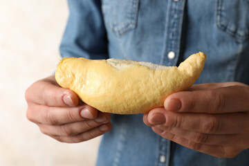 Woman holding peeled fresh ripe durian, closeup