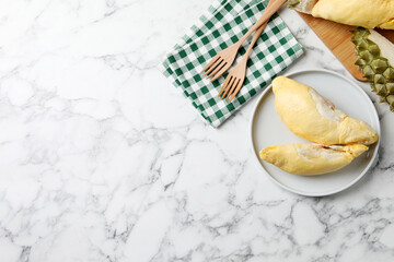 Pieces of fresh ripe durian on white marble table, flat lay. Space for text