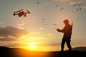 Silhouette of soldier are using drone and laptop computer for scouting during military operation...