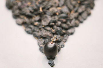 Blue grapes and blue raisins on the background.