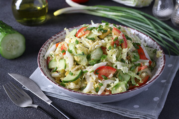 Salad with Chinese cabbage, tomatoes, chives, eggs and cucumber, dressed with olive oil