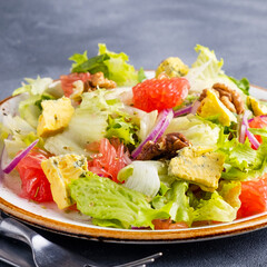 Diet salad with grapefruit, mold cheese and walnuts. Closeup