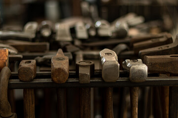 Assortment of Blacksmith Hammers Hanging on a Rack