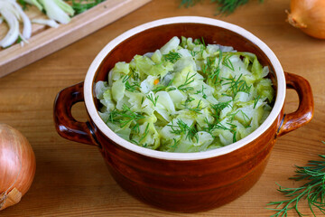 Stewed young cabbage sprinkled with chopped dill. Spring vegetable dishes. Vegetarian cooking