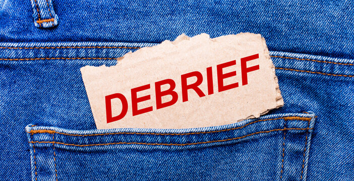 In the back pocket of the jeans there is a brown piece of paper with the text DEBRIEF