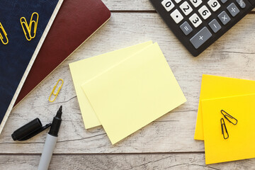 sticky note on office desk with stationery and office supplies. Blank sticker for copy or text...