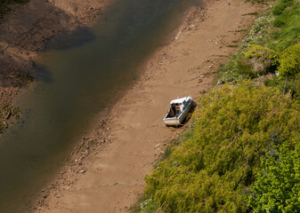 Fototapeta na wymiar Small boat stranded on a tidal river bank