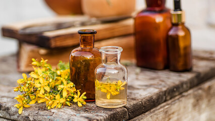 Hypericum perforatum, St. John's wort apothecary bottles with tincture and essential oils for...