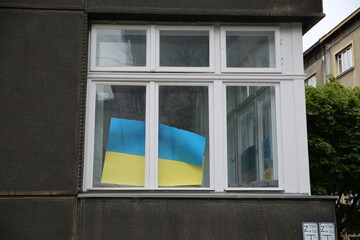 Flag of Ukraine in the house window in Krakow, Poland