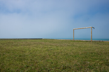 Fototapeta na wymiar Soccer field in the countryside. View on sea.
