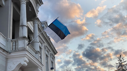 The official state symbol of Estonia is a flag with a blue, black and white stripe against a blue sky fluttering in the wind