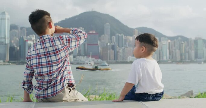Brother give snack to his little brother at outdoor