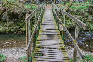 Wooden bridge over the river Gauchach in need of repair. The Gauchach Gorge is the little sister of...