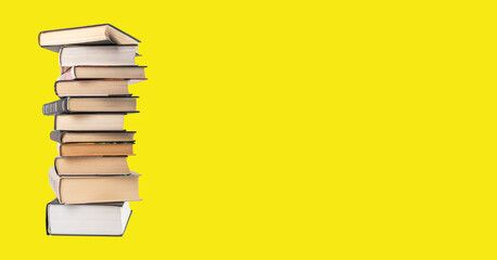 Ad school banner with stack of classics books, literature pile on yellow background with copy...