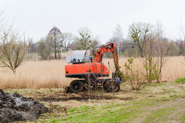 Modern tractor machinery plowing agricultural field meadow at farm at spring autumn. Farmer cultivating and make soil tillage before seeding plants and crops, nature countryside rural scene