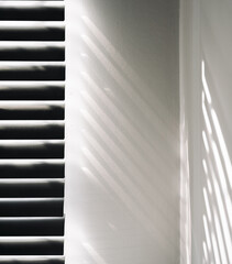 Lights shadows. Abstract light, black shadow overlay from window on white texture wall. Sunlight architecture background. Textures Light reflection from the window.