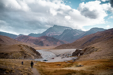 Horizontal shot of people hiking in the mountainous valley of Cajon del Maipo, Chile.