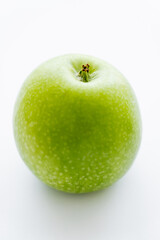 delicious whole green apple on white.