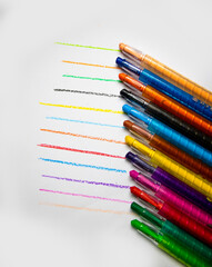 Drawing pencil like a rainbow on white background, selective focus