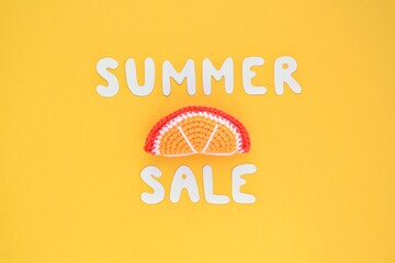 Slice of orange and lettering Summer sale on yellow background. Banner with percentage sign. Promotion of the poster sale or percent discount in the store. Mock up, top view, flatlay concept