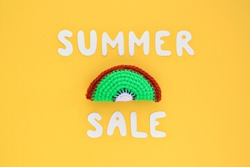 Slice of kiwi and lettering Summer sale on yellow background. Banner with percentage sign. Promotion of the poster sale or percent discount in the store. Mock up, top view, flatlay concept