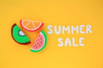 Slices of watermelon, kiwi, orange and lettering Summer sale on yellow background. Banner. Promotion of the poster sale or percent discount in the store. Mock up, top view, flatlay concept