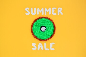 Slice of kiwi and lettering Summer sale on yellow background. Banner with percentage sign. Promotion of the poster sale or percent discount in the store. Mock up, top view, flatlay concept