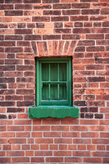 Green window on brick wall