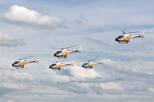 RAF Waddington, Lincolnshire, UK - July 6, 2014: Spanish Air Force Eurocopter EC-120B Colibri helicopter from the Patrulla Aspa display team performing an aerial display.