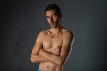 Portrait of an attractive stylish man posing against dark background