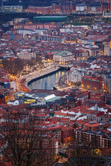 Fototapeta premium Aerial view on Bilbao center with red roofs and Nervion river.