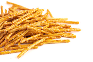 A Pile of Extra Thin Salted Stick Pretzels Isolated on a White Background