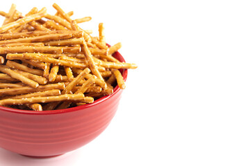 A Bowl of Extra Thin Salted Stick Pretzels Isolated on a White Background