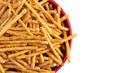A Bowl of Extra Thin Salted Stick Pretzels Isolated on a White Background