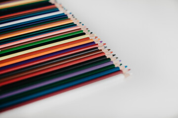 Different colored pencils on a white table