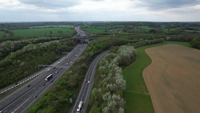 junction of the M25 motorway with the M1 motorway UK drone aerial view panning shot
