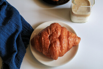 Warm Fresh Buttery Croissants with coffee for breakfast. French and American Croissants and Baked Pastries. Healthy eating and sweet food concept.