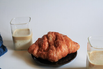 Warm Fresh Buttery Croissants with coffee for breakfast. French and American Croissants and Baked Pastries. Healthy eating and sweet food concept.