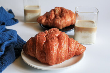 Warm Fresh Buttery Croissants with coffee for breakfast. French and American Croissants and Baked Pastries. Healthy eating and sweet food concept.