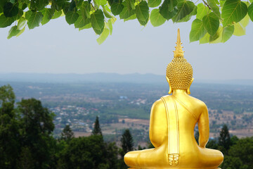 Buddha statue. background blurred flowers and sky with the light of the sun.Makha Bucha Day.Vesak Day.Asanha Bucha.Buddhist Lent.